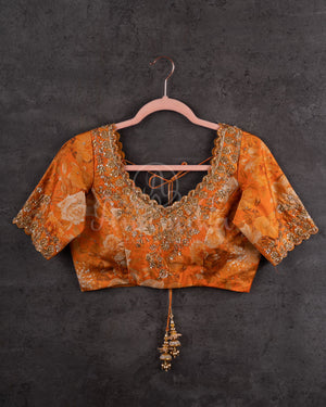 Crushed Tissue Saree in peach paired with a floral work blouse