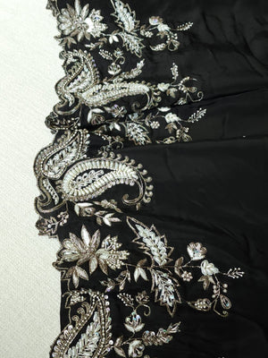 A pure crepe saree in black with stunning silver embroidered border