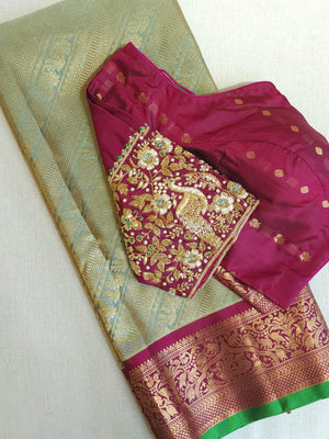 A Royal Gadwal kanchi saree in sage green with rich magenta border
