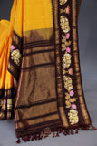 Yellow Gadwal Pattu saree with brown border and tanjore painting