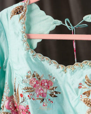 A beautiful Floral blouse in pastel blue with intricately designed embroidery