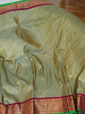 A Royal Gadwal kanchi saree in sage green with rich magenta border