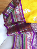 Venkatagiri Pattu saree in yellow with a contrast purple blouse