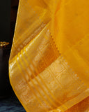 Kanchi soft silk saree in yellow paired with a contrast orange blouse