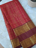 A stunning vintage kanjeevaram in rust orange with a deep maroon border