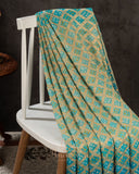 A Bandini Georgette saree in hues of blue paired with a blue pearl work blouse