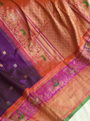 A Royal Gadwal kanchi saree in purple with contrast turning meena border