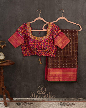 Brown kanjeevaram saree with a contrast dark pink border and Patola blouse