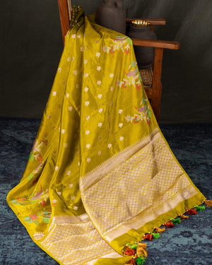 Mustard yellow organza saree with a contrast orange blouse