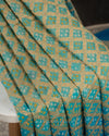 A Bandini Georgette saree in hues of blue paired with a blue pearl work blouse