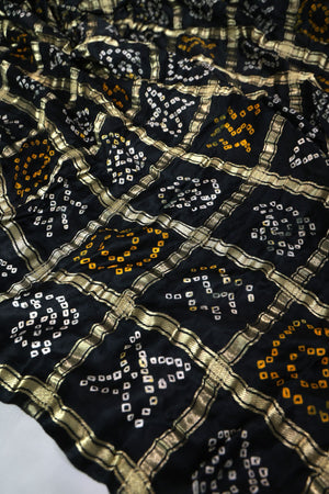 Black Bandini Gharchola saree with a showstopper blouse patter