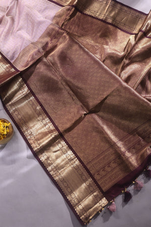 Kanchipattu saree in a lovely shade of light peach with a contrast dark maroon border