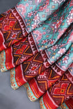 A classic patola in aqua blue with a striking contrast red