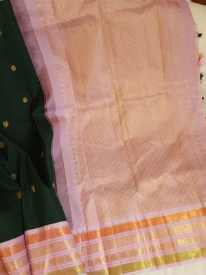 Kanjeevaram saree in bottle green with a baby pink border