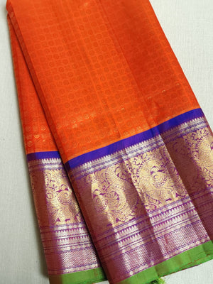 A grand Gadwal Kanchi saree in orange for your joyous occasions