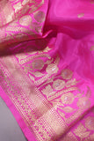 Raw Mango saree in bubble gum pink paired with a contrast dark green blouse