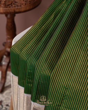 Dark green kanjeevaram saree with contrast grey border and pallu