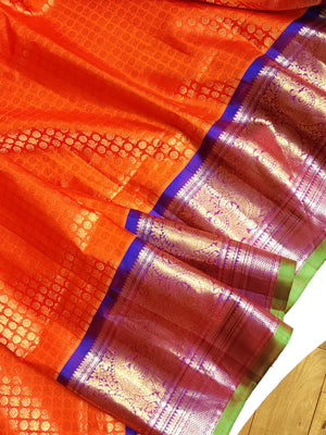 A grand Gadwal Kanchi saree in orange for your joyous occasions