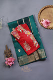 A lovely organza saree in shaded dark green with a red designer blouse
