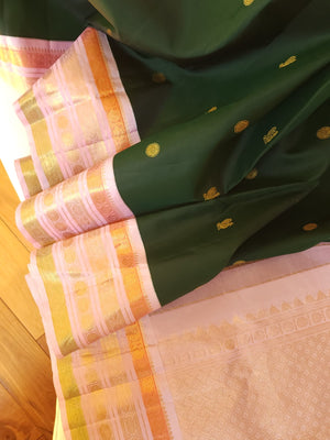 Kanjeevaram saree in bottle green with a baby pink border