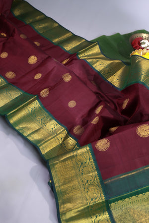 An exquisite kanjeevaram saree in deep maroon and emerald green combo