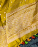 Mustard yellow organza saree with a contrast orange blouse