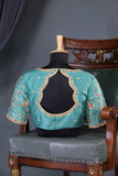 A classic patola in aqua blue with a striking contrast red