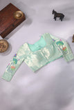 Muslin jamdaani in peach paired with a contrast mint green paithani blouse