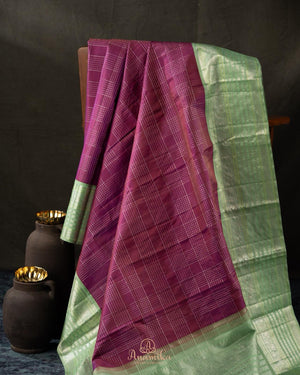 A kanjeevaram saree in purple with pastel green combo