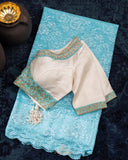 A contemporary lace saree in pastel blue with a stunning blouse pattern