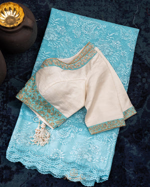 A contemporary lace saree in pastel blue with a stunning blouse pattern