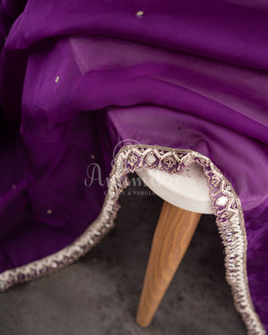 Organza saree in lovely purple with a zardosi work border and a heavily embroidered cap sleeve blouse