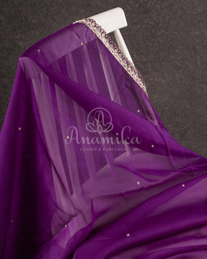 Organza saree in lovely purple with a zardosi work border and a heavily embroidered cap sleeve blouse