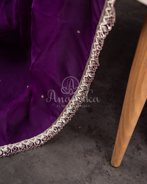 Organza saree in lovely purple with a zardosi work border and a heavily embroidered cap sleeve blouse