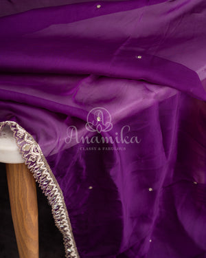Organza saree in lovely purple with a zardosi work border and a heavily embroidered cap sleeve blouse