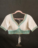 A contemporary lace saree in pastel blue with a stunning blouse pattern