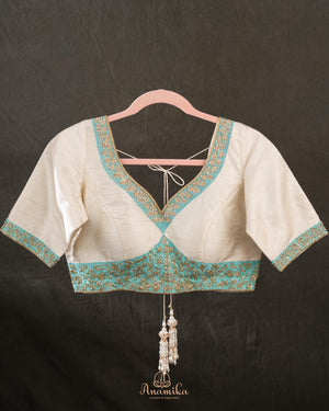 A contemporary lace saree in pastel blue with a stunning blouse pattern