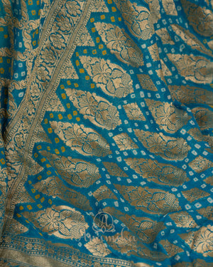 A Bandini Georgette saree in hues of blue paired with a blue pearl work blouse