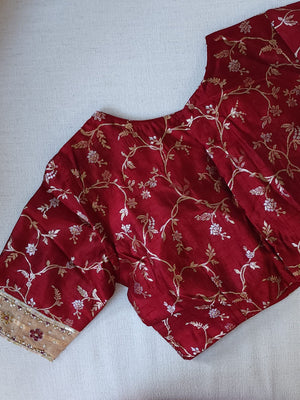 Banarasi Gold Tissue saree paired with a contrast maroon blouse