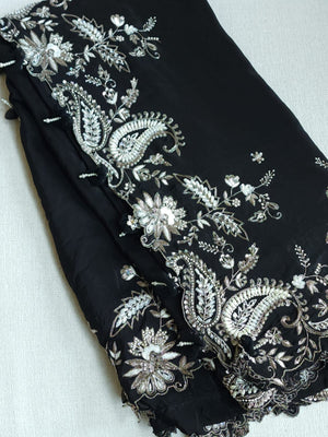 A pure crepe saree in black with stunning silver embroidered border