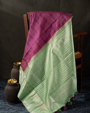 A kanjeevaram saree in purple with pastel green combo