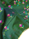 Bottle Green Jamdaani saree paired with a contrast yellow paithani blouse