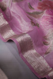 A beautiful rose pink tissue saree with an off white blouse