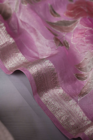 A beautiful rose pink tissue saree with an off white blouse