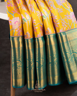 A meenakari kanjeevaram saree in yellow and teal