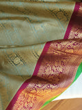 A Royal Gadwal kanchi saree in sage green with rich magenta border