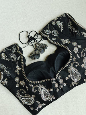 A pure crepe saree in black with stunning silver embroidered border