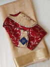 Banarasi Gold Tissue saree paired with a contrast maroon blouse