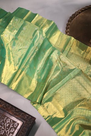 Green Tissue Kanchi saree with a contrast off white blouse