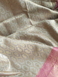 Kanjeevaram in a beautiful shade of gray with a contrast pink border.